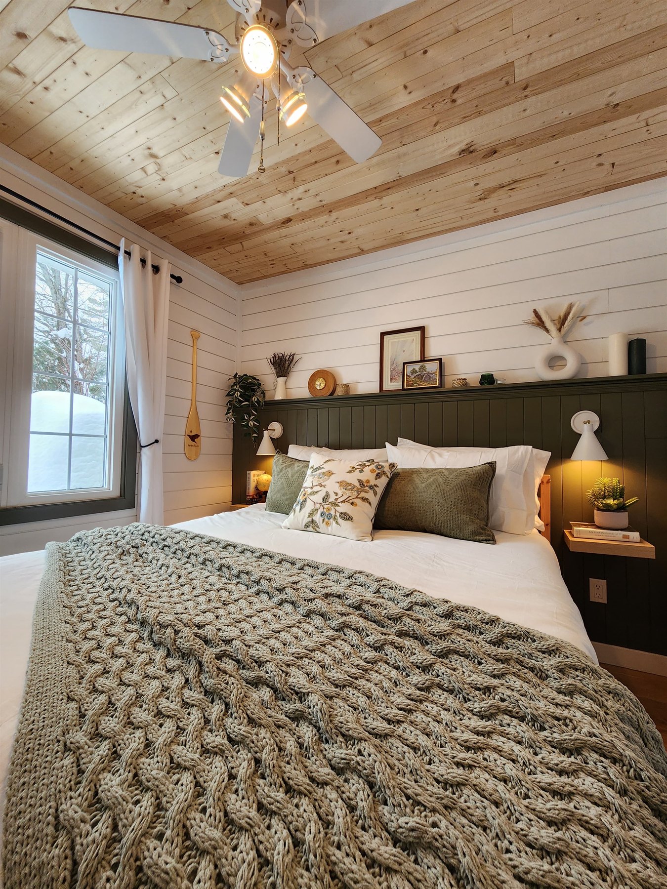 Second queen bedroom with a green panelled headboard wall