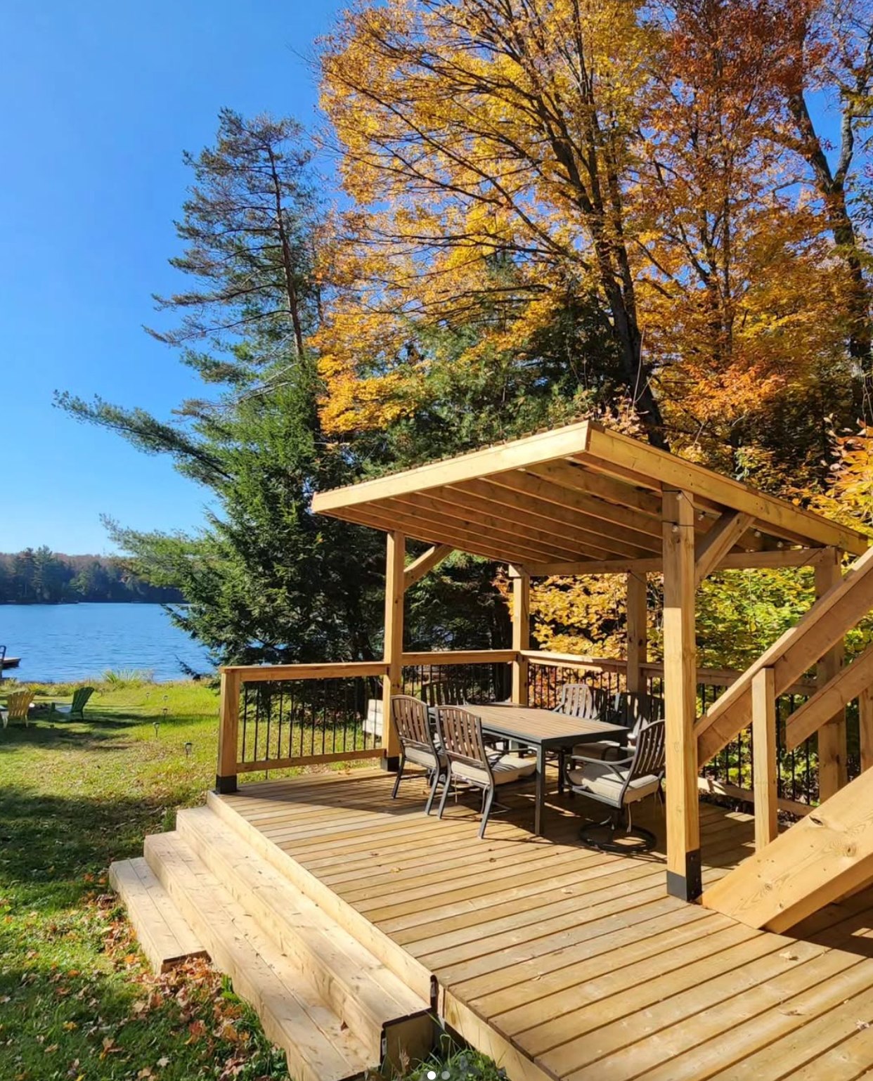 Covered deck with dining table beside the lake