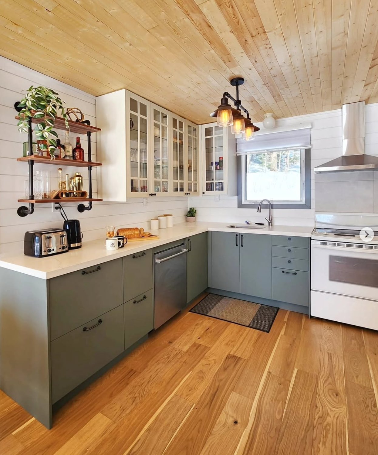 Kitchen with green cabinets and pine ceiling